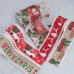 Detailed view of Christmas burlap and sheer ribbon with frayed edges and festive holiday prints.
