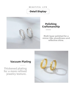 Detail view of mini hoop earrings with hammered texture and polished metallic finish