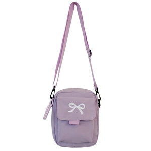 Detail view of purple nylon crossbody bag featuring a white bow embroidery and zipper