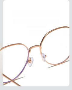 Detailed close-up of soft silicone nose pads and metal bridge on stylish square glasses