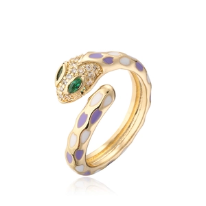 Detail of 18k gold plated snake ring showing purple enamel and green crystal eyes