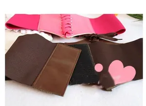 Detail of wide elastic corset belts with lace-up design in rose red and brown colors