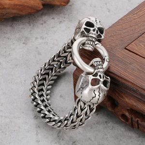 Gothic skull bracelet in vintage silver stainless steel with double skull clasp on wood