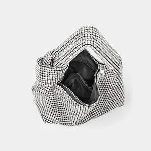 Sparkling silver rhinestone knotted handbag with a top zipper and polished black inner lining