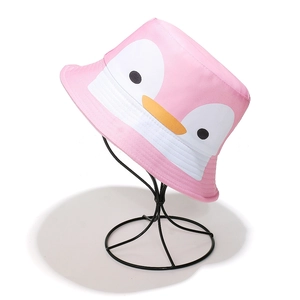 Detail shot of a pink bucket hat with a cute cartoon penguin face and yellow beak design