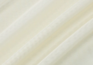Macro view of white mesh fabric texture and sheer pleated details on summer dress