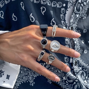 Detail of 6-piece silver punk ring set with skull bird and black gemstone on hand