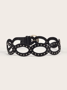 Detail of PU leather belt showing oval cut-outs with silver studs and golden round buckle
