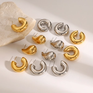 Golden and silver stainless steel teardrop and chunky hoop earrings set on stone