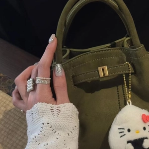 Vintage style square pearl ring with zircon inlays worn with a green suede handbag