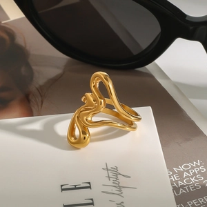 Minimalist 18k gold irregular liquid line heart ring on a fashion magazine background