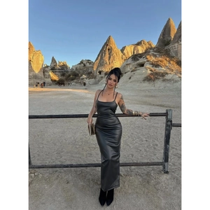 Dettaglio di un abito bodycon in pelle PU nera con lacci sulla schiena al tramonto