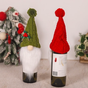 Set of two knitted Christmas gnome wine bottle covers in festive red and green colors