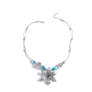 Bohemian silver necklace with turquoise beads and intricate floral heart pendants