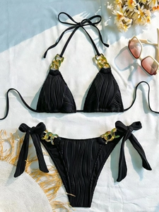 Sexy black halter bikini set with gold chain accents and textured fabric on white background