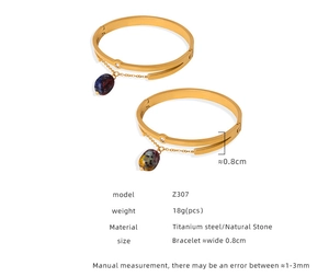 Detailed view of titanium steel gold bracelet with oval natural stone and zircon