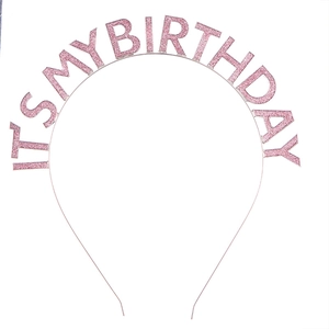 Detail view of pink glitter 'IT'S MY BIRTHDAY' lettering on metal birthday headband