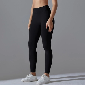 Detail of black high-waisted seamless yoga leggings with wide tummy control waistband
