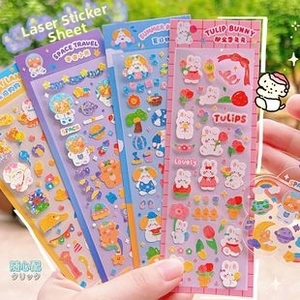 Detail of holographic cartoon stickers with space and tulip rabbit designs in sunlight