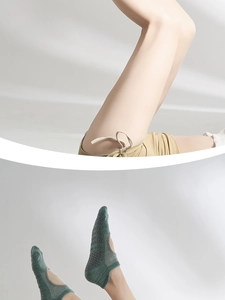 Detail of dark green mesh yoga socks with non-slip grips and low-cut backless design
