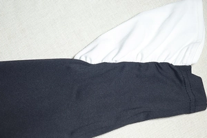 Close-up of black and white contrast flared cuffs on a knitted A-line dress