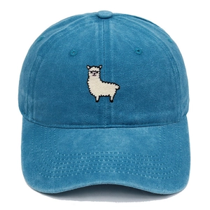 Detailed close-up of white alpaca embroidery on sky blue washed cotton baseball cap