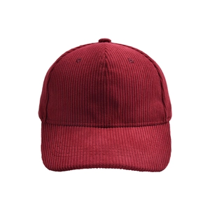 Close-up of deep red corduroy texture and stitching detail on the baseball cap