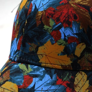 Macro detail of high-quality canvas fabric with colorful autumn maple leaf print texture