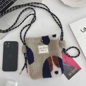 Detailed texture of plush heart-shaped crossbody bag with cute beagle pattern and woven strap