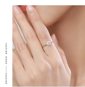 Detail of S925 silver flower ring with pink gemstone and zircon micro-paving on finger