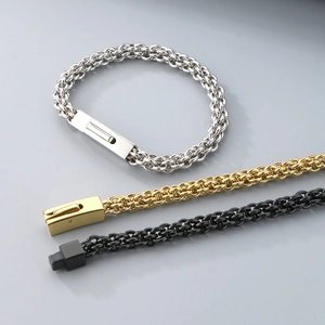 Flat lay of titanium steel woven chain bracelets in gold, silver and black with snap clasps