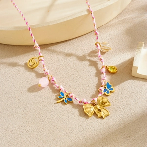 Bohemian woven rope necklace featuring a gold bow, blue butterflies, and colorful charms