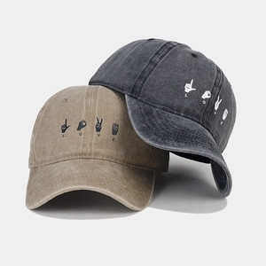 Détail de casquettes vintage en coton délavé avec broderie LOVE signe de main
