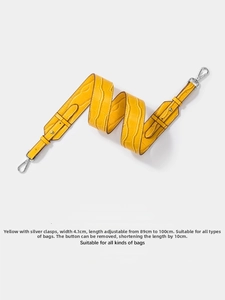 Detail of yellow crocodile pattern wide bag strap with silver metal buckle and adjustable length