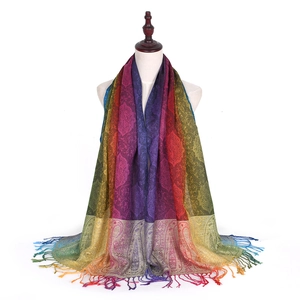 Detail of colorful paisley jacquard scarf with gradient fringe and soft woven texture