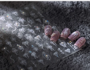 Detail showing 3D bow and pearl nail stickers TL-240 on lavender French manicure base
