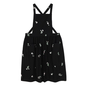 Black cotton linen apron with floral embroidery and large front pockets on white background