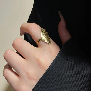 Macro view of 18k gold plated stainless steel ring with detailed ginkgo leaf design