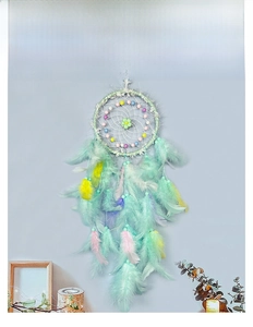 Close-up of handmade mint green dreamcatcher featuring soft feathers and colorful beads