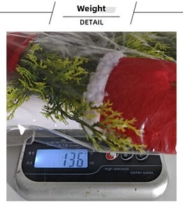 Detail shot of 136g weight measurement for the lighted Christmas gnome wreath decoration