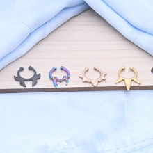 Detailed macro view of four metallic nose rings in black, rainbow, gold, and rose gold finishes