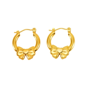 Close-up of golden bow-knot hoop earrings with twisted metal texture and spring closure