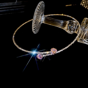 Close-up of sparkling pink heart-shaped crystal necklace on a silver rhinestone chain