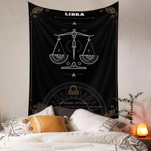 Detail of black Libra constellation tapestry with gold stars on a bedroom wall