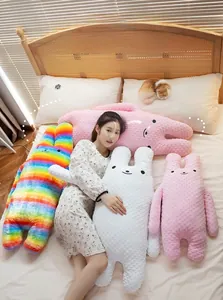 Detailed view of long-eared rabbit pillows in soft rainbow and pink fleece fabric