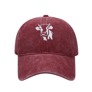 Close-up of cow embroidery on vintage washed cotton baseball cap in deep burgundy