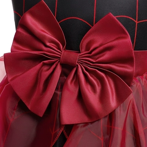Detail of red bow and spider web pattern on a shiny satin Halloween witch costume dress