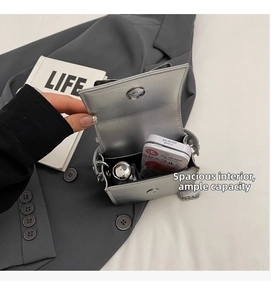 Silver mini crossbody bag interior showing magnetic clasp and daily essentials storage
