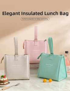 Detailed view of insulated lunch bags in beige, pink, and green on marble surface