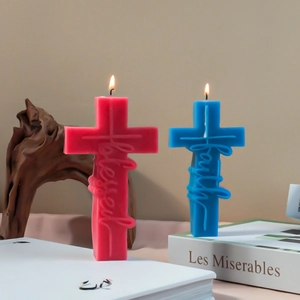 Set of pink and blue cross candles with Blessed and Faith embossed text in home setting
